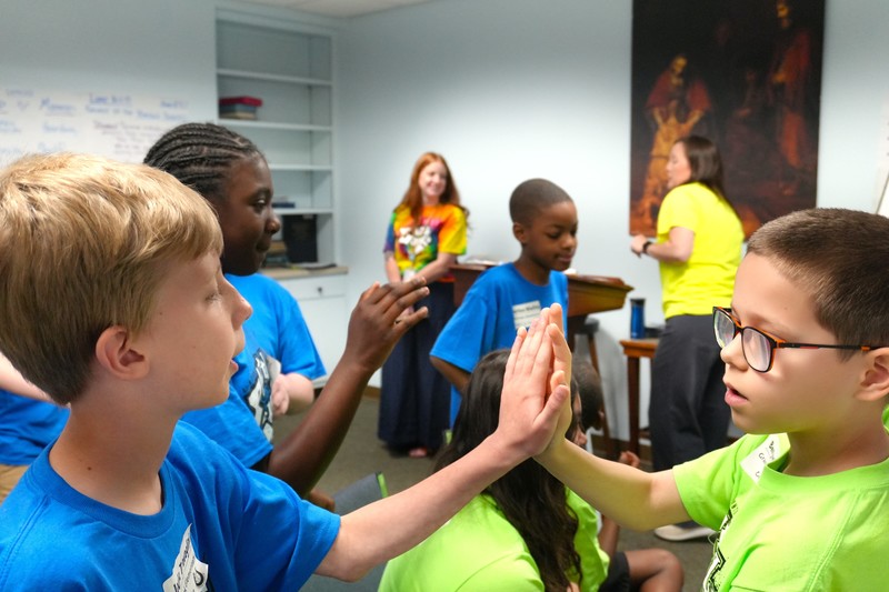 Students high five following Battle of the Books.