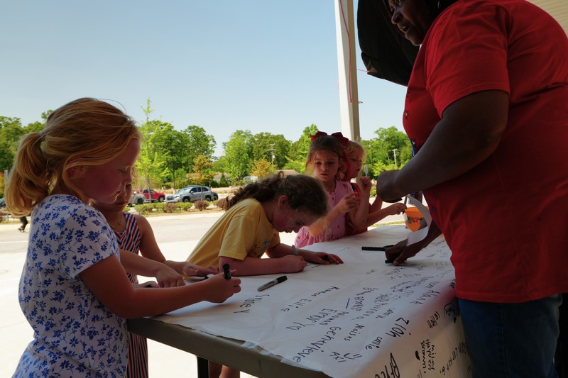 Millbrook students sign banner after completing walk-a-thon event.