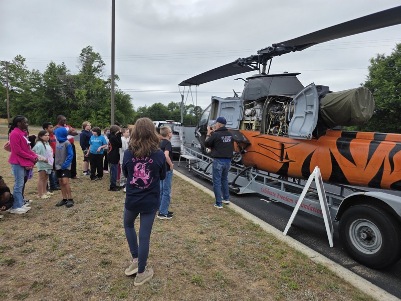 Students exploring helicopter.