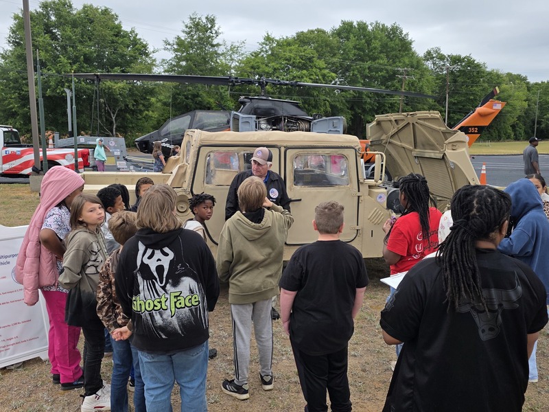 Students exploring humvee.