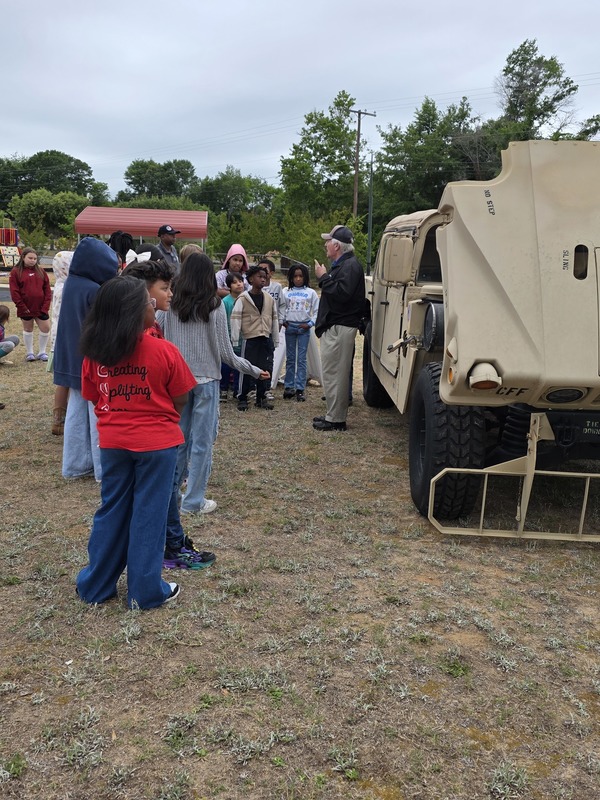Students exploring humvee.
