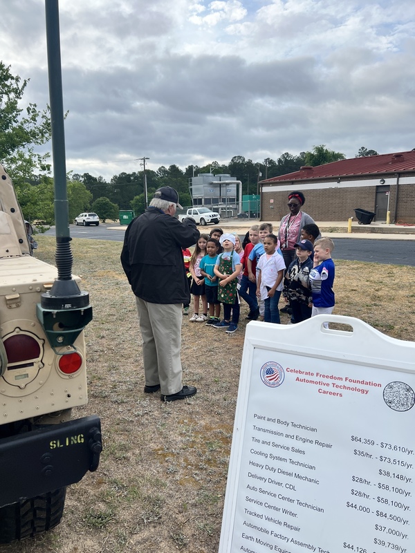 Students exploring humvee.