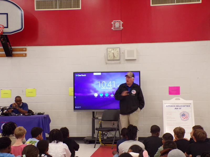 Speakers in front of students.