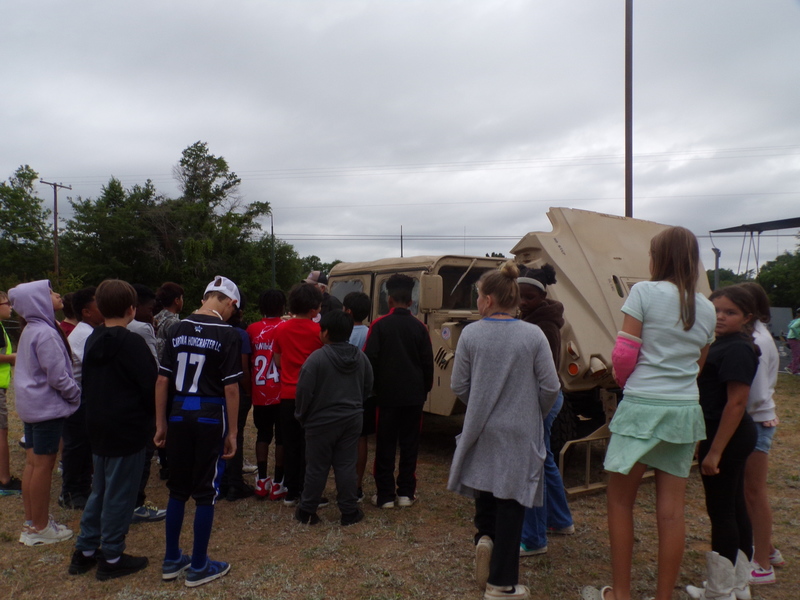 Students exploring humvee.