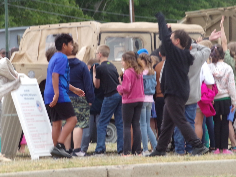 Students exploring humvee.