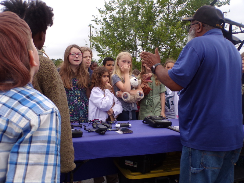 Drone operator speaking to students.