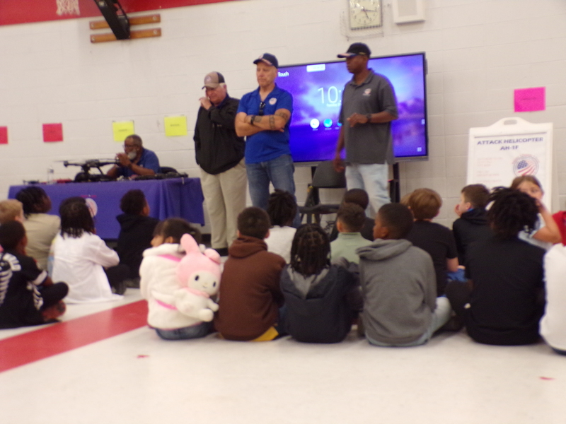 Speakers in front of students.