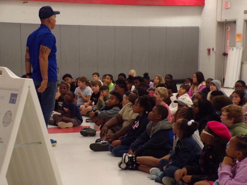 Speakers in front of student audience.