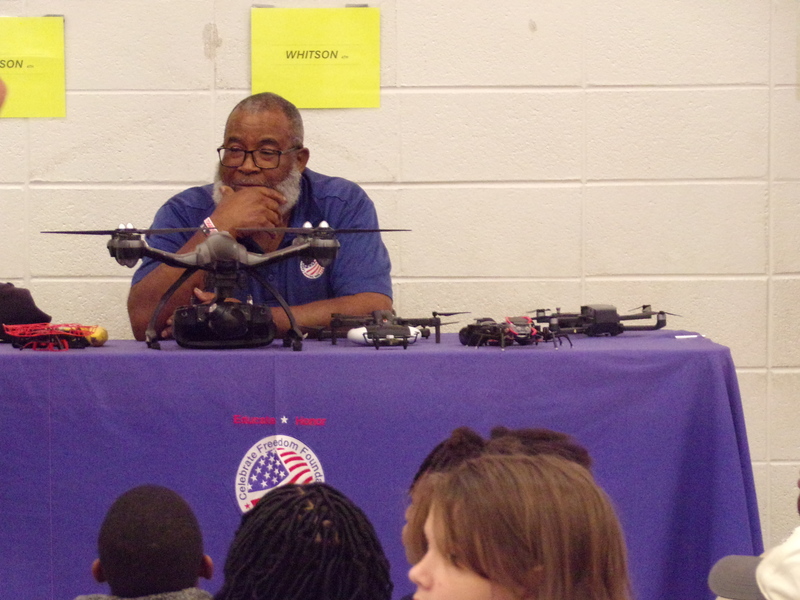 Drone operator sitting at table with drones.