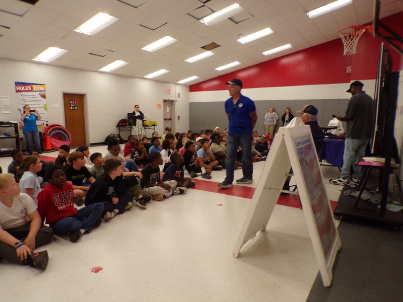 Speakers in front of student audience.