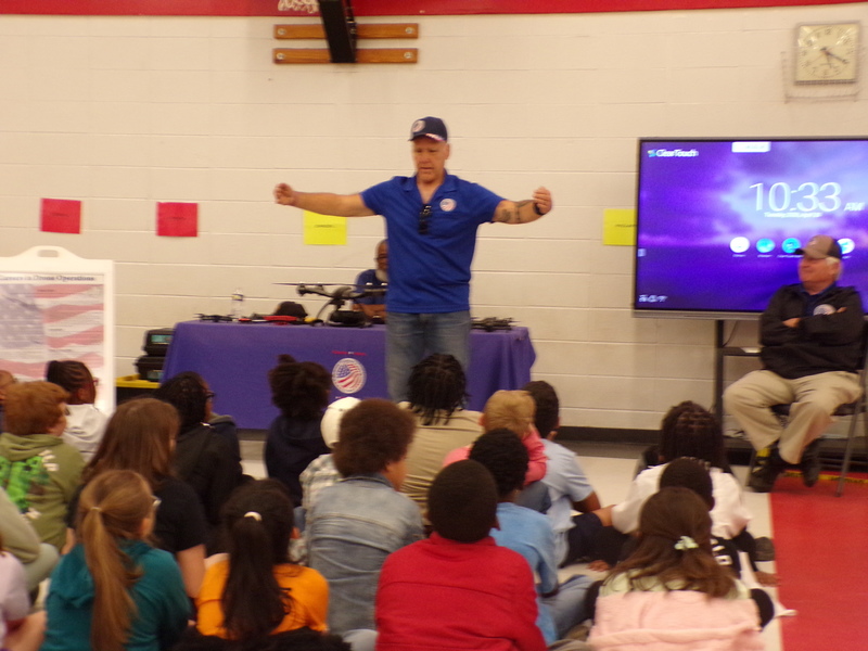 Speakers in front of student audience.