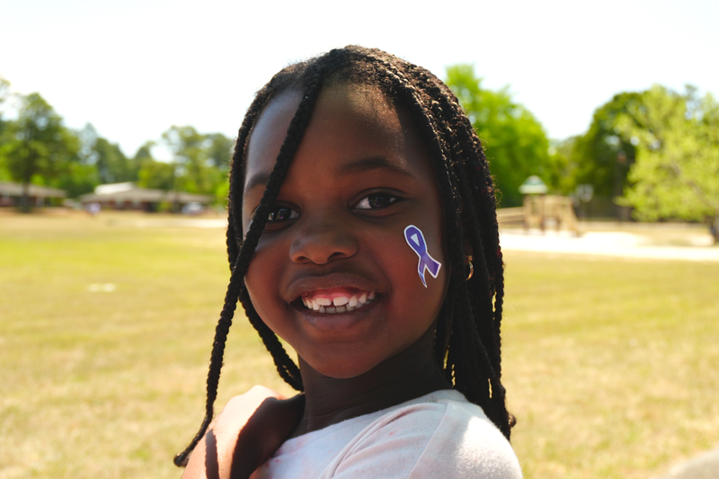 A Gloverville Elementary student wears a purple ribbon sticker for military families.