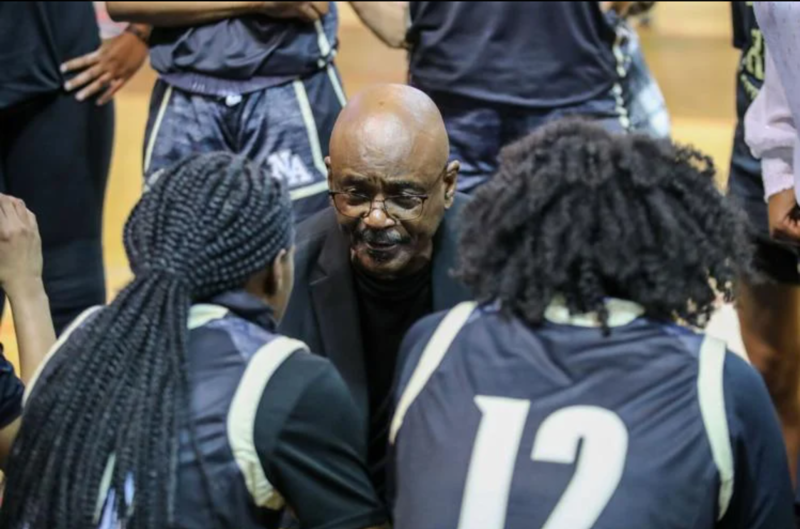 Al Young speaks in a huddle with his girls basketball team at North Augusta.