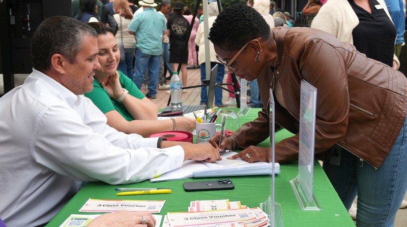 Transportation employee signing in at ACPSD booth.