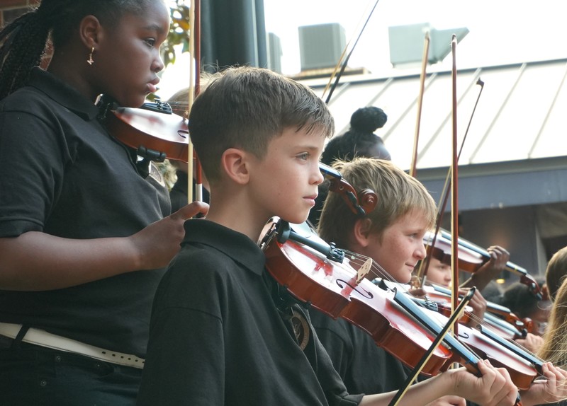 Students of Youth Strings playing violins.