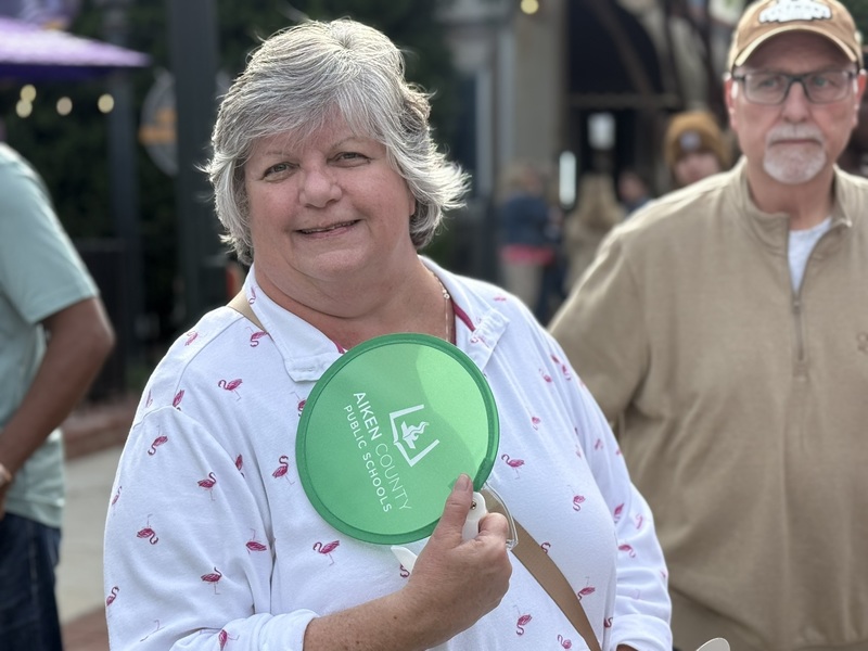 ACPSD employee holding fan merch.