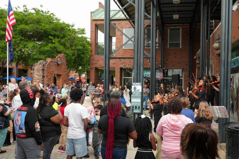 Crowd of attendees watching performance from Youth Strings.