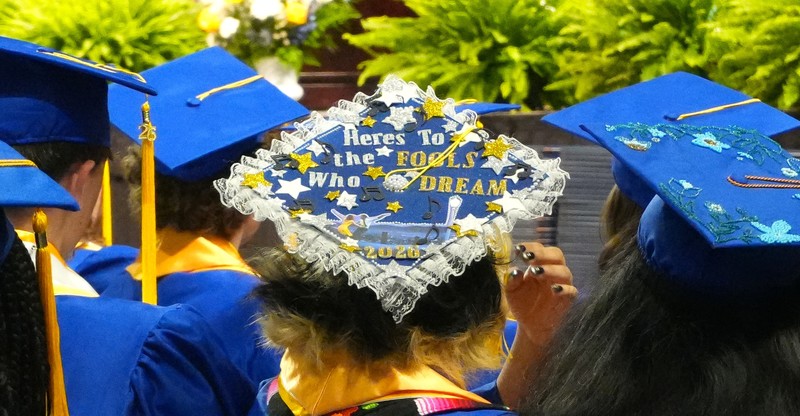 Decorated graduation cap that reads 'Here's to the fools who dream 2026'.