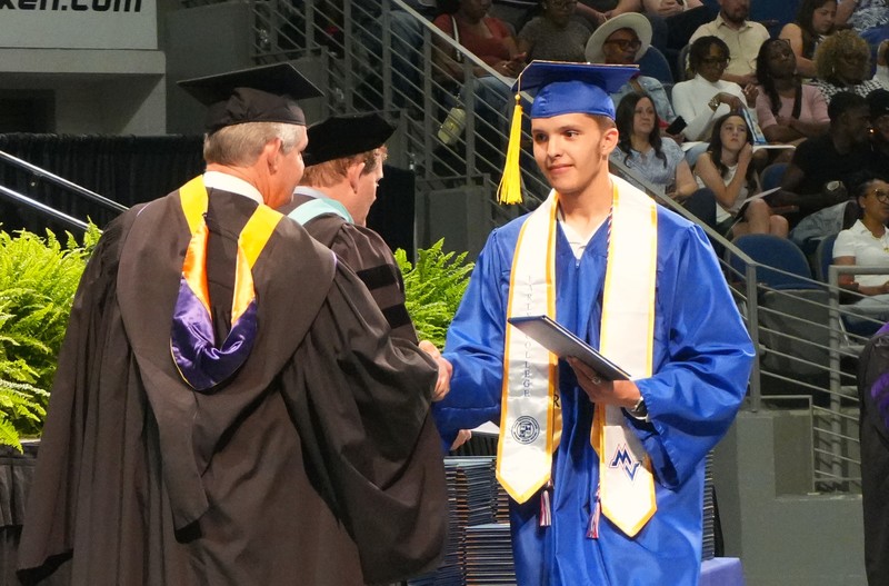 A Midland Valley senior receives his associates degree during Aiken Tech graduation.
