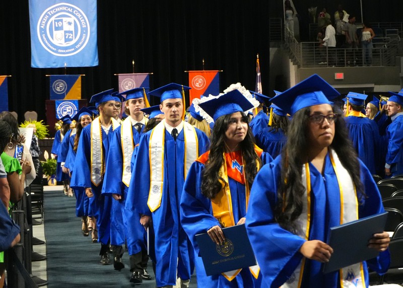 Midland Valley students exit graduation with diplomas in hand.
