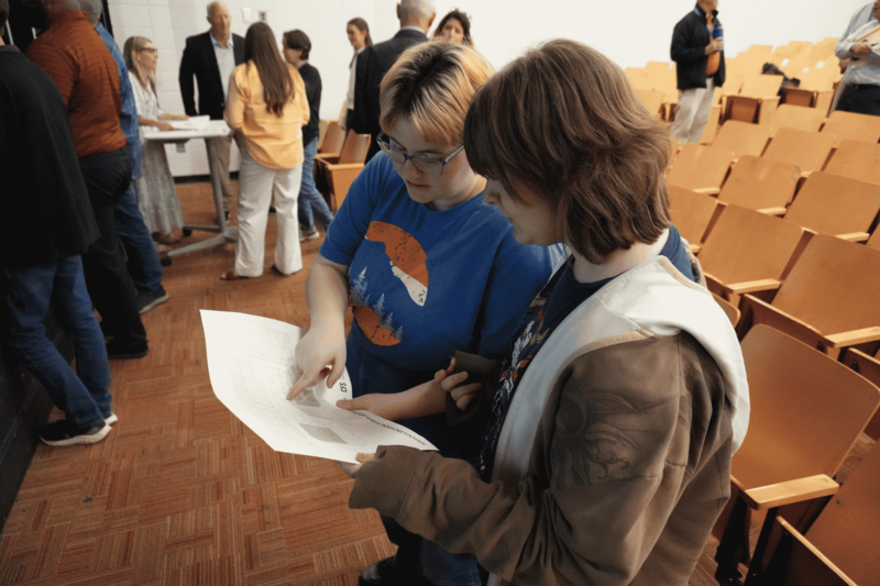 Two students looking at drafted map SAHS renovations.