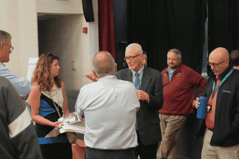 Group of people talking at input meeting.