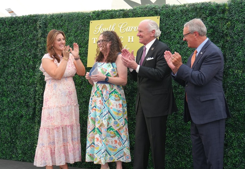 State superintendent Ellen Weaver, Governor Henry McMaster and a BMW representative stand with Dr. Palladino as she was named SC Teacher of the Year.