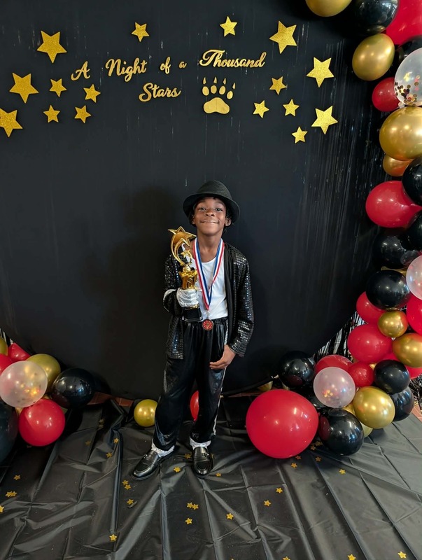 Student holding trophy.