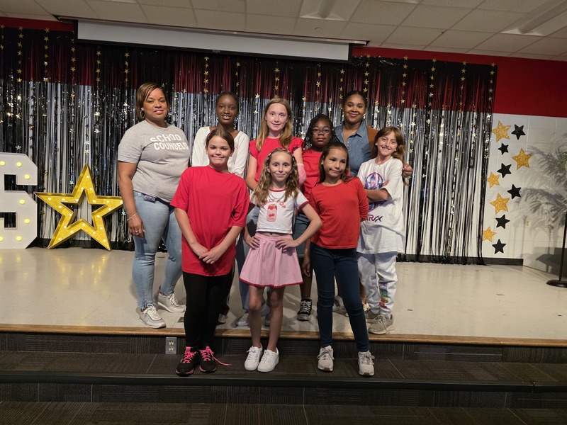 Dance team posing on stage.