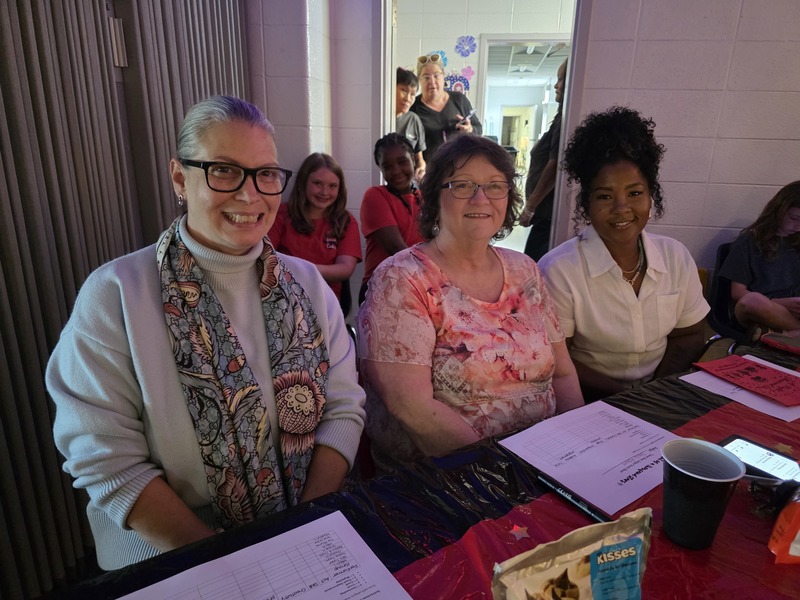 Three talent show judges sitting at table