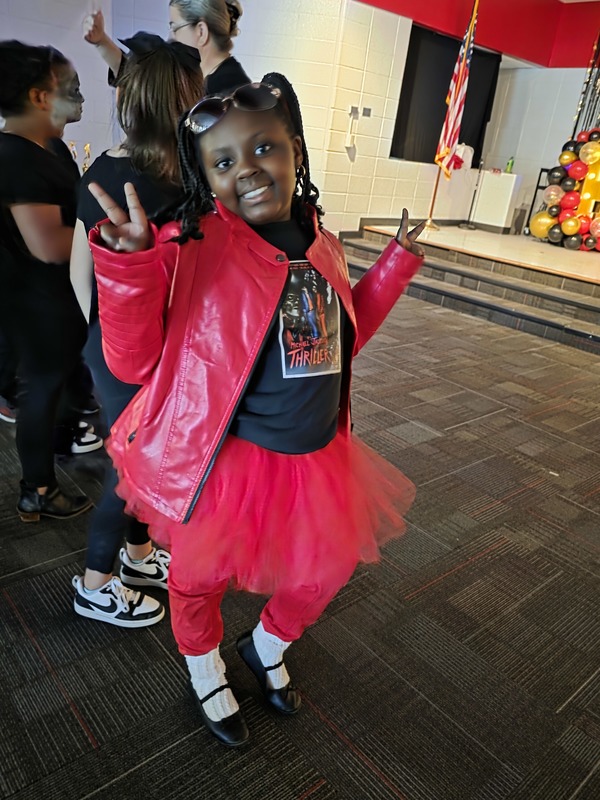 Student in red tutu posing.
