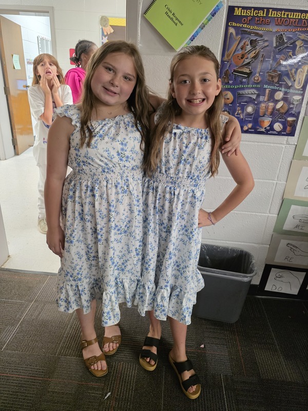 Students standing with arms around each other.