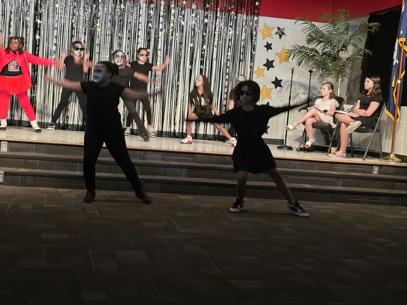Students performing on stage.