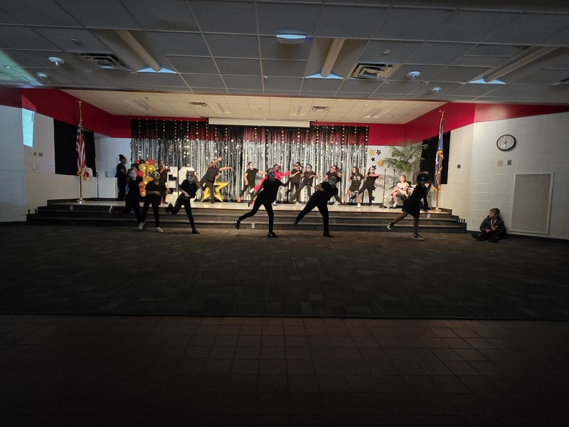 Students performing on stage.