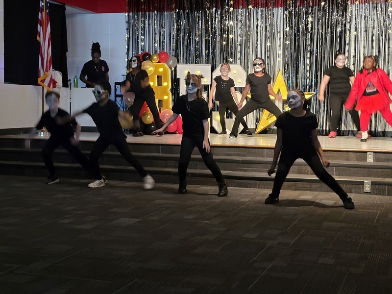 Students performing on stage.
