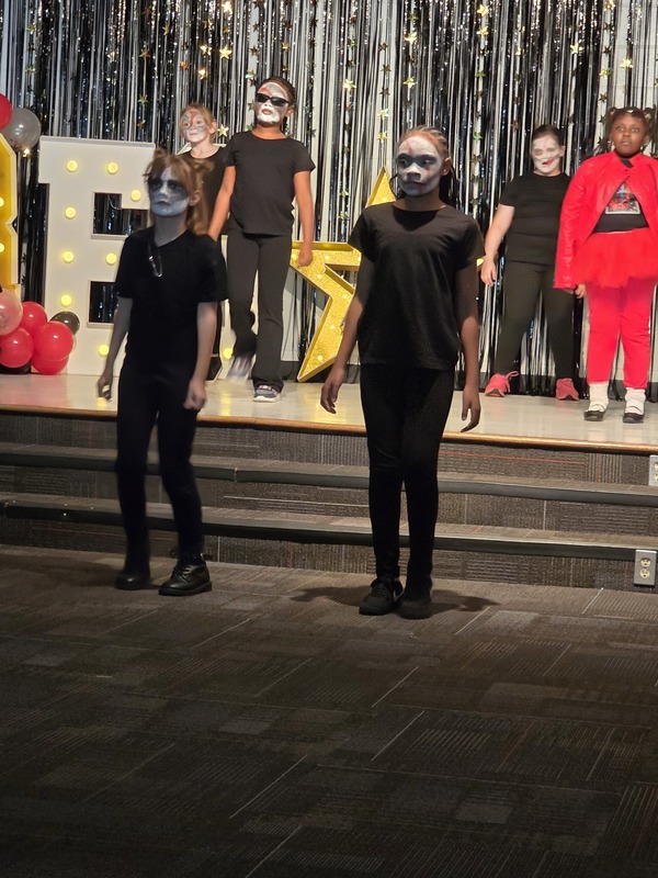 Students performing on stage.