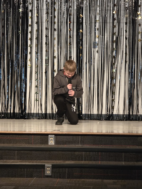 Students performing on stage.