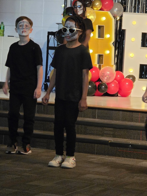 Students performing on stage.
