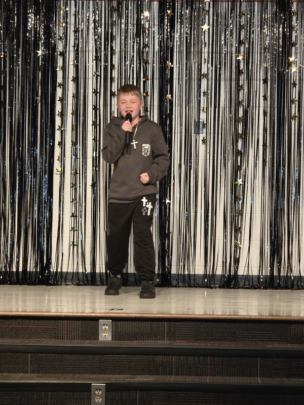 Students performing on stage.