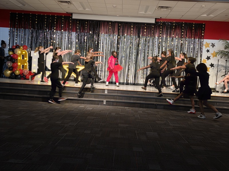 Students performing on stage.