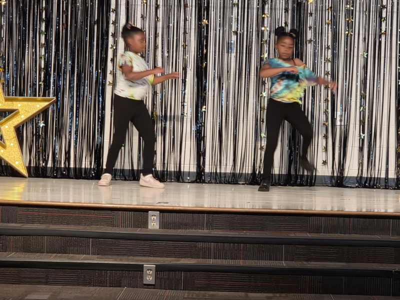 Students performing on stage.