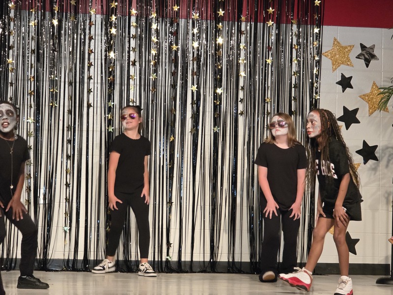 Students performing on stage.