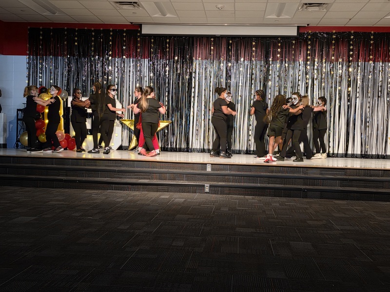 Students performing on stage.