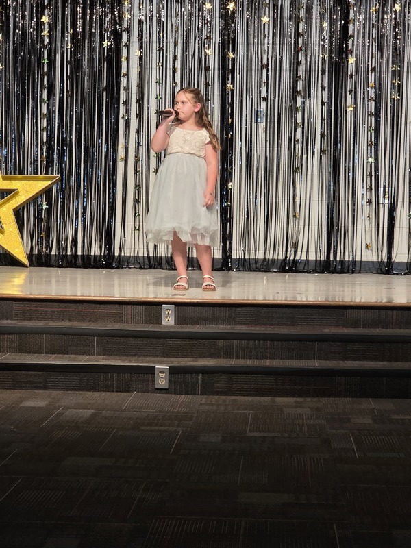 Students performing on stage.