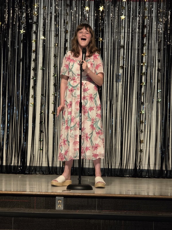 Students performing on stage.