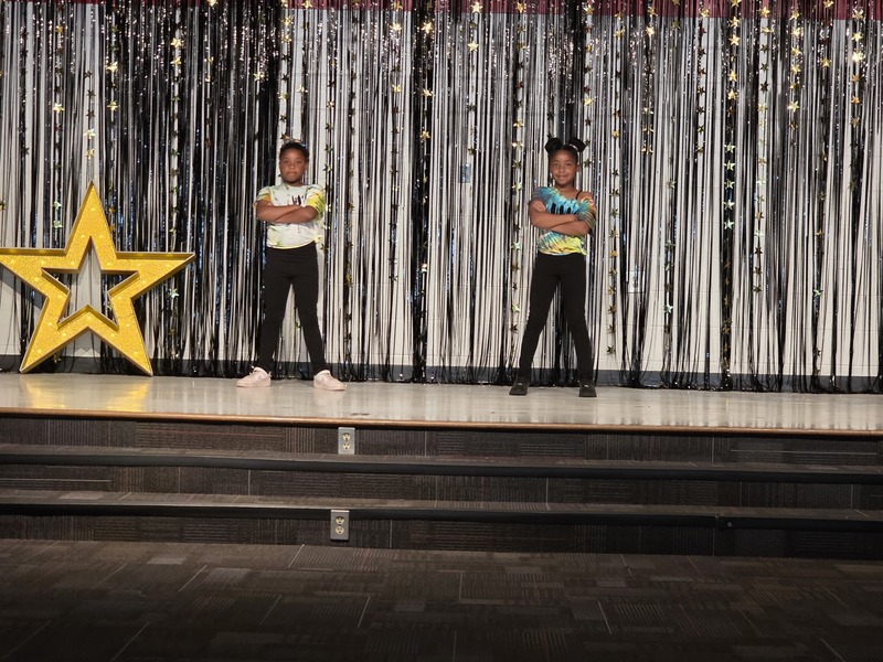 Students performing on stage.
