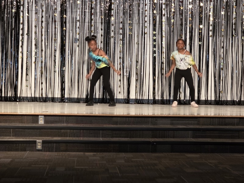 Students performing on stage.