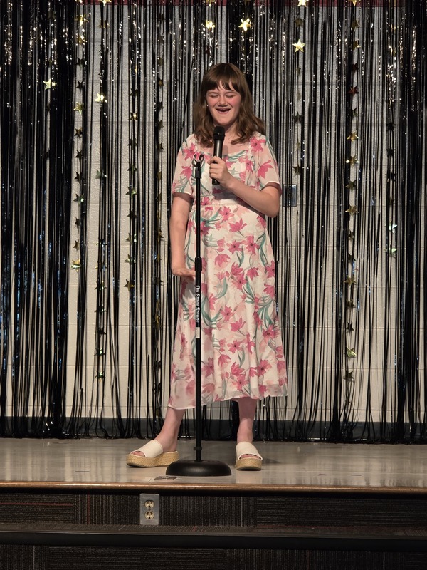 Students performing on stage.