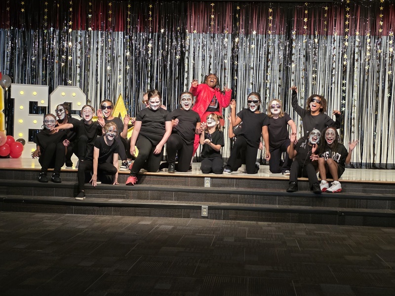Students performing on stage.