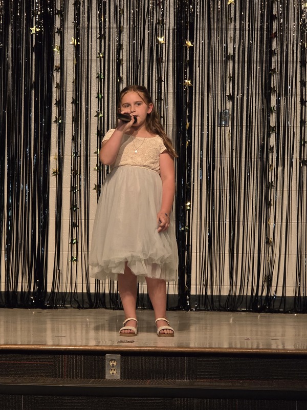 Students performing on stage.